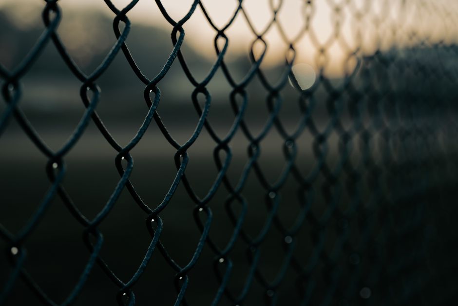 Galvanized chain link fence along a commercial property line