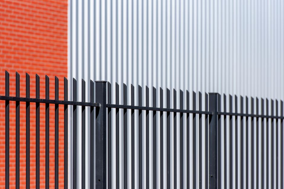 Black steel security fence outside a commercial building