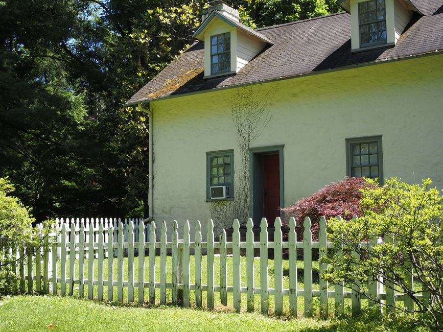 White picket fence in front of a cottage