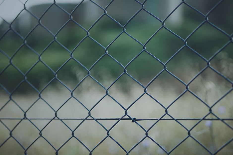 Chain link fence beside an open field