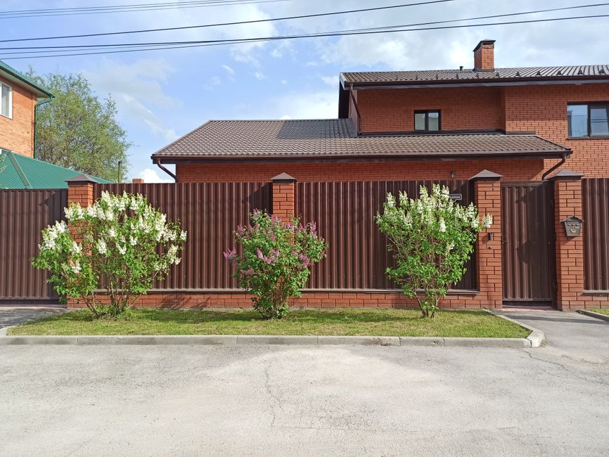 Metal fence in front of a brick house