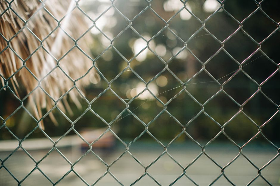 Galvanized chain link fence around a yard