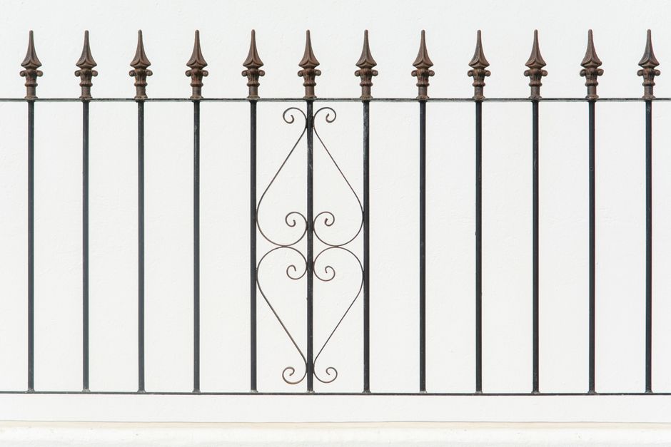 Black wrought iron fence with decorative scrollwork